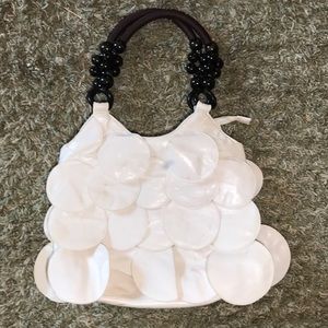 White leather mod flapper purse.  Black interior.